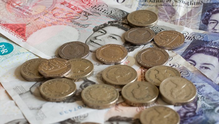 A close-up image of pound coins and notes
